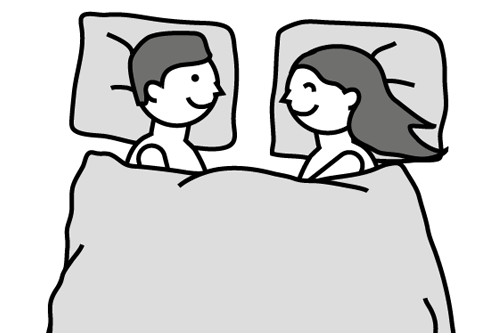 Piirroksessa hymyilevät mies ja nainen peiton alla sängyssä, päät tyynyillä, toisiaan kohden kääntyneinä.